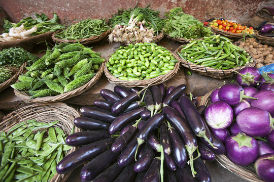 various Indian vegetables in baskets at a street shop