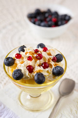 Closeup of a dessert with berries and cream