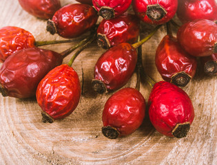 Fototapeta na wymiar Dried rose hip berries on the wooden table.