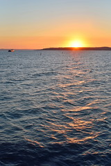 The view of the sunset over the Crimea with a ferry