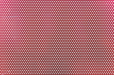 Background of red metal plate perforated with white dots