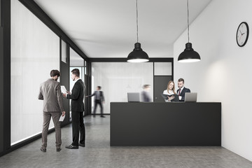 People talking and walking near the reception desk