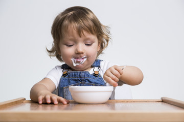 Content boy eating his porridge