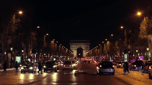 Triumphal arch. Paris. France. Static camera, real time. Place Charles de Gaulle. Famous touristic architecture landmark. Symbol of french glory. World historical heritage. Evening traffic. Toned