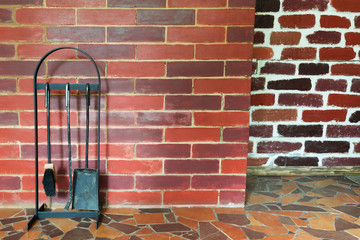 on the brick wall background stand objects for cleaning the oven