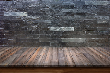 Empty top of wood table on black marble stone wall background.