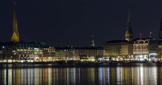 Hamburg, Germany - Binnenalster with reflections in downtown Hamburg with view over Jungfernstieg, tower of townhall and steeple of church St. Petri - Timelapse with zoom out - April 2016
