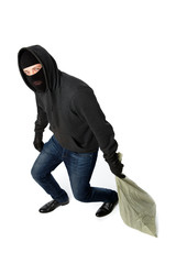 Thief in gloves carries bag