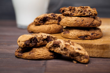 Round cookies with chocolate on a wooden table. Sweet pastries.