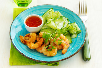 Salad with cucumber Asian style with fried shrimp.