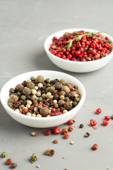 mixture of peppercorns on a white plate