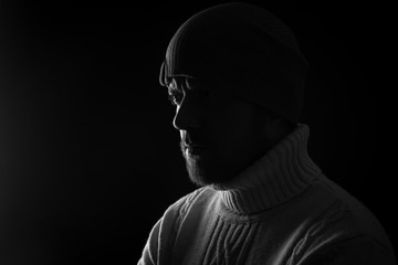 Mature man with a beard in the black wool hat