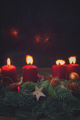 Evergreen fir tree advent garland with burning candles on wooden background, copy space on black...