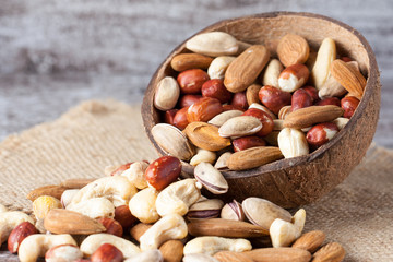 Healthy mix nuts on wooden background. Almonds, hazelnuts, cashews, peanuts, brazilian nuts