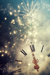 Abstract background with fireworks and clock close to midnight