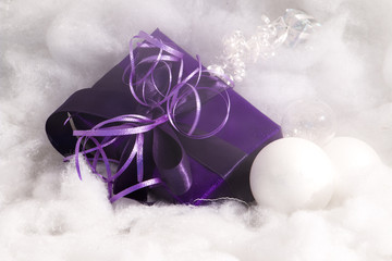 Purple christmas gift with bulbs and smoke