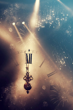 Abstract background with fireworks and clock close to midnight