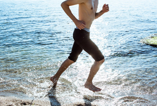 Close up picture of man running in the water