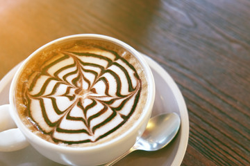Mocha coffee (also called Caffe Mocha) with wooden saucer. Interior coffee shop. Main ingredients...