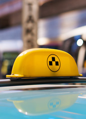 Taxi sign on the roof of the car.