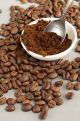 teaspoon ground coffee on a gray background