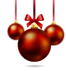 Isolated red Christmas ball hanging on a ribbon