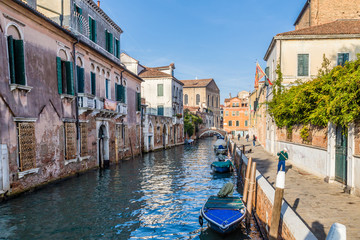 Fototapeta na wymiar Streetview with bridge and old buildings in Venice Italy.