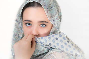 Portrait of young woman covered with a headscarf. - obrazy, fototapety, plakaty