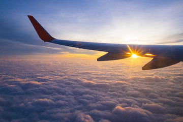 Naklejka na ściany i meble Sunrise and beautiful cloud view from window of aircraft