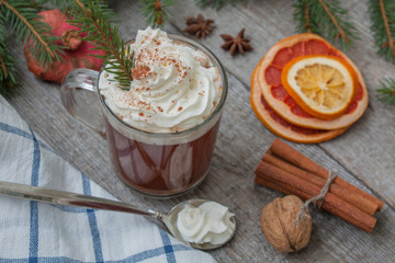 Christmas cocoa with whipped cream, chocolate, walnuts, cinnamon