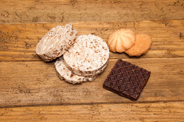 Round breads and biscuits and chocolate on Board.