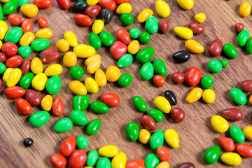 Fototapeta na wymiar Colorful candy scattered on the wooden table.
