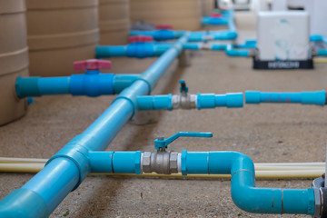 Blue water pipe installation from pump to tank.