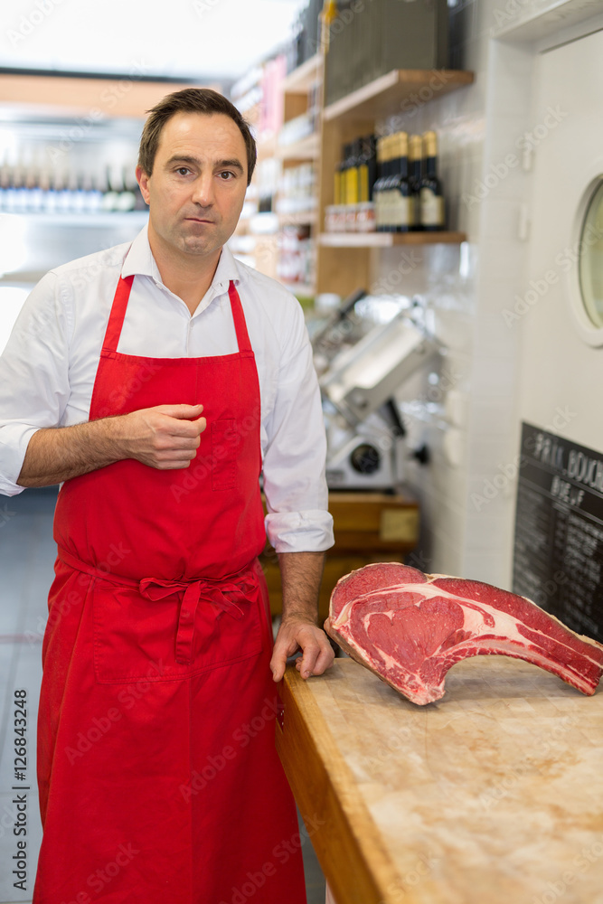 Wall mural Butcher presenting meat