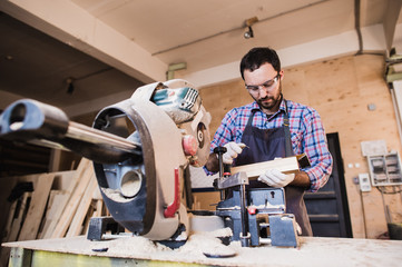 Framing contractor using a circular cut off saw to trim wood studs length.