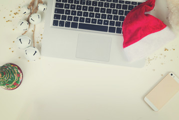Flat lay, top view office table desk. Workspace with laptop and christmas decorations on white background, retro toned