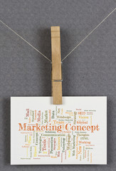 Marketing Concept word cloud on a business card pinned up on a board
