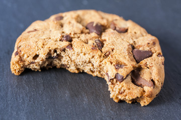 One rounded bitten cookie isolated on stone background