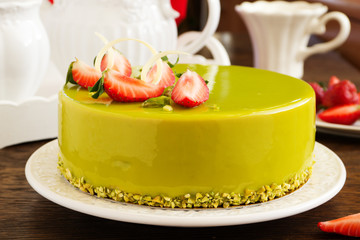 Delicious strawberry-pistachio mousse cake with a smooth glaze.