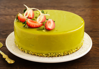 Delicious strawberry-pistachio mousse cake with a smooth glaze.