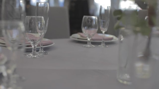 the waiter displays forks on a holiday table