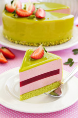 Delicious strawberry-pistachio mousse cake with a smooth glaze.