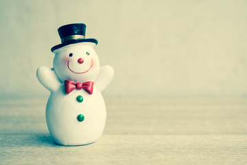 Snowman with vintage filter, On wooden table.