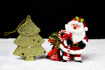 Christmas trees and santa claus and bells on black background