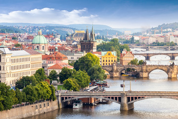 Fototapeta na wymiar Panorama of the old part of Prague from the Letna park. Beautiful view on the bridges over the river Vltava at sunset. Old Town architecture, Czech Republic.