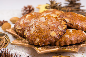 Christmas cookies with almond nuts and ginger on golden star plate