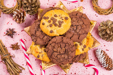 Christmas chocolate cookies and candy canes on golden plate