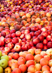 Fresh apples and peaches in a fruit shop
