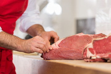 Butcher Preparing Meat In Shop