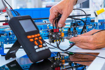 Adjusting an industrial robot with a CNC computer control